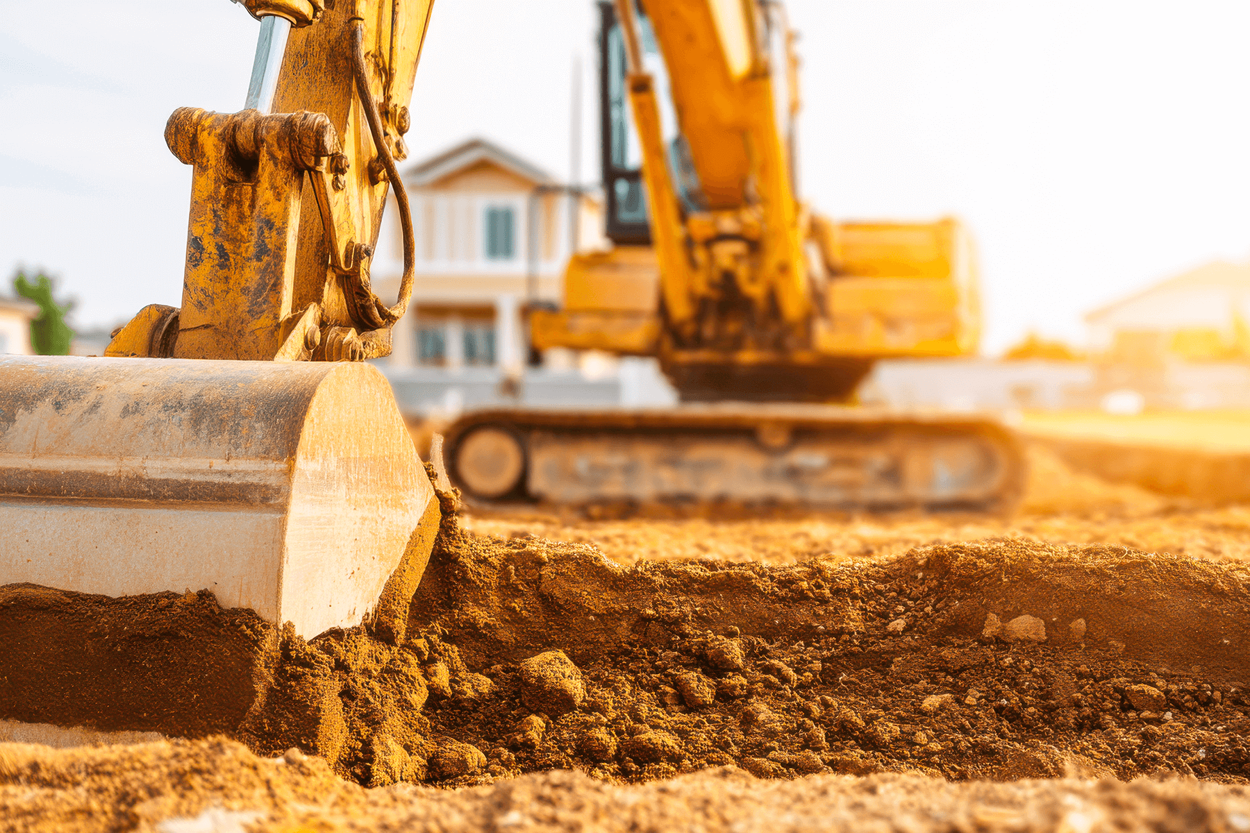 Bagger hebt Erde auf Baustelle aus, Symbol für Baubeginn und solide Umsetzung durch HIS Hausbau